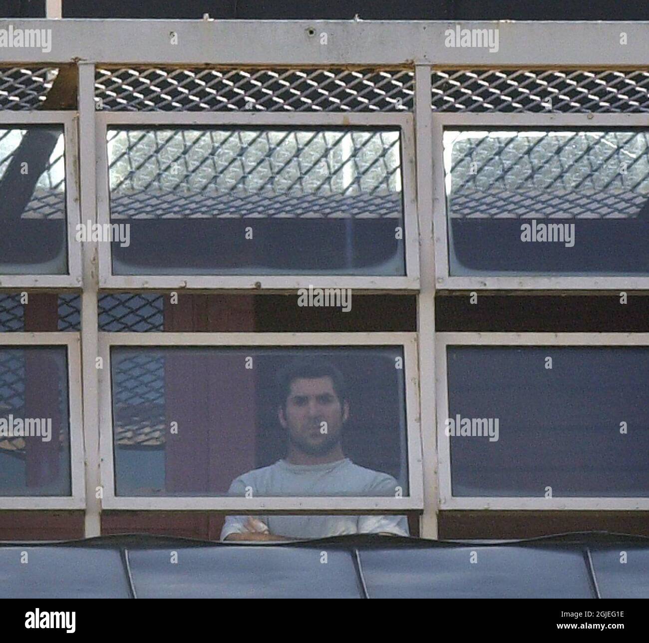 Canadian ice hockey player Yvon Corriveau, who plays for German league club Eisbaren Berlin, looking out from the exercise yard at a remand prison in Kristianstad, Sweden. Corriveau and his teammate Brad Bergen were arrested after being accused of sexually assaulting a local girl during their pre-season tour. Stock Photo