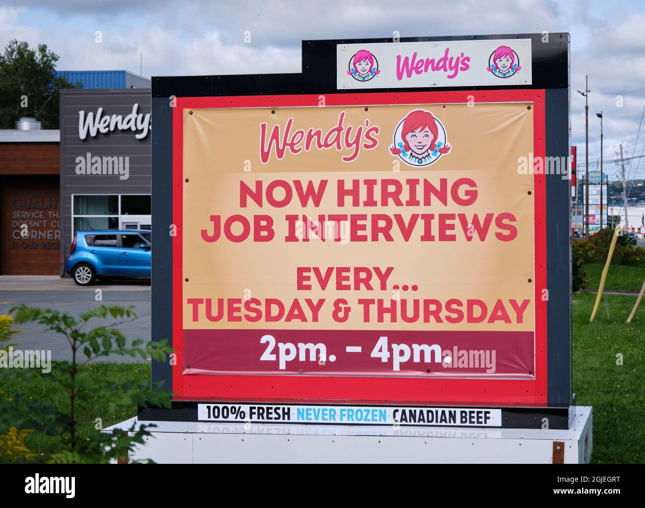 Sign at Wendy's fast food restaurant 'Now Hiring' interviews twice a week Stock Photo