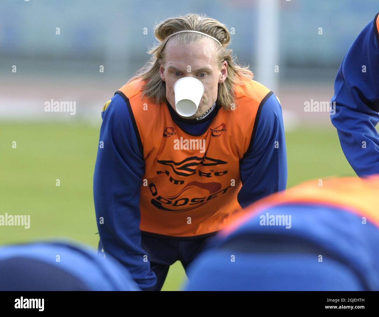 Sweden's Johan Mjallby jokes around with a plastic cup during training