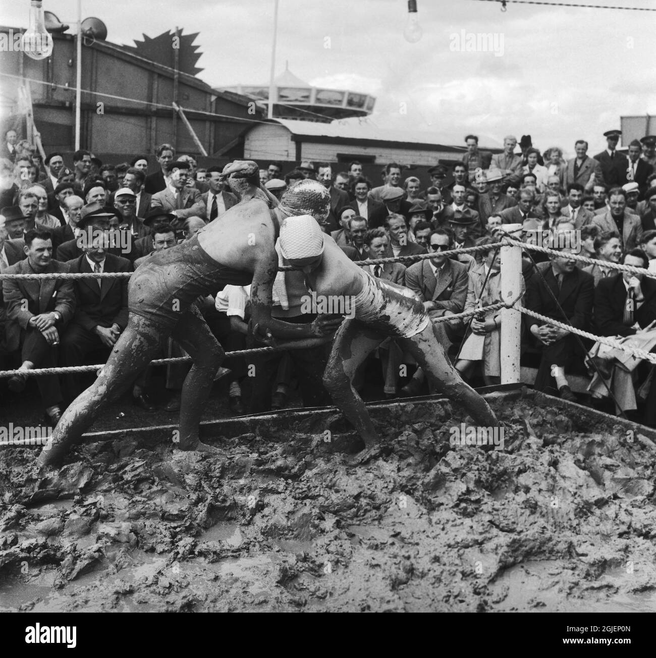 Mud wrestling ladies draw a large crowd at the annual market in Kivik, Sweden. Stock Photo