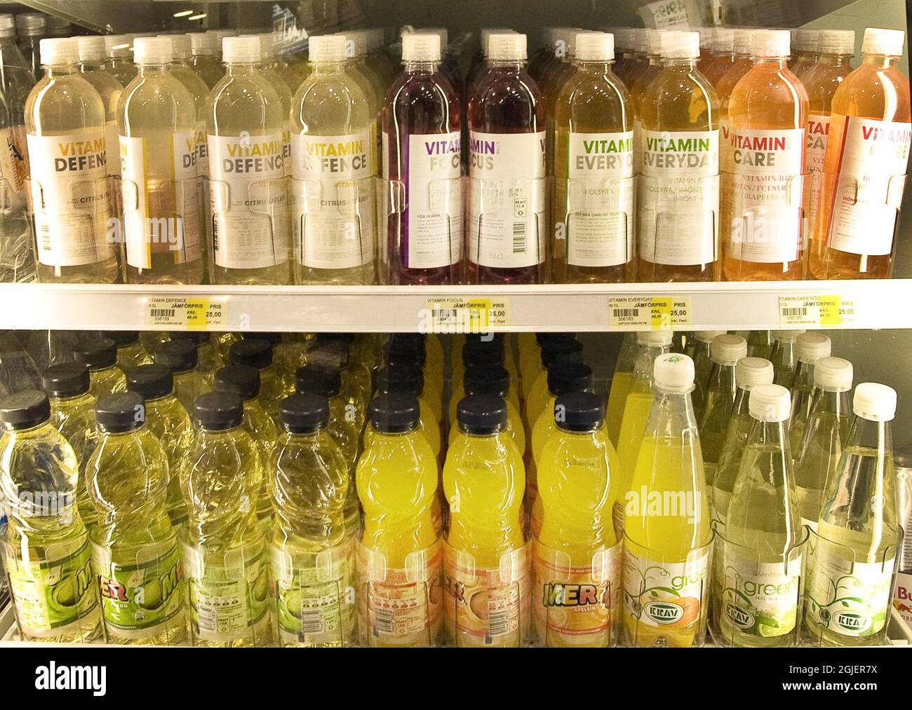 Soft drinks of various flavours on shelves in a grocery store Stock
