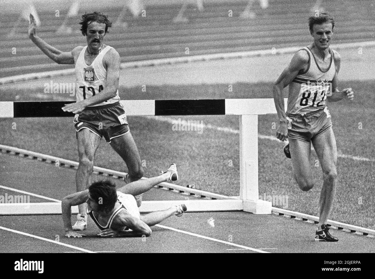 Anders Garderud sprinting for the gold medal in 3000 meter steeplechase at the Olympic Games in Montreal 1976. Baumgartl from East Germany has just fallen over the last hurdle and Malinowski from Poland takes a jump over him running for silver. Stock Photo