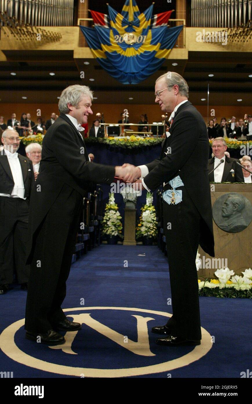 Doctor Paul M. Nurse, left, receives the Nobel Prize in physiology or medicine from King Carl XVI Gustaf of Sweden, right, before a gathering of more than 170 laureates invited for the Nobel centennial at the Concert Hall in Stockholm, Sweden. Doctor Nurse, from London, Great Britain, shares the prize with Leland H. Hartwell, USA, and R. Timothy Hunt, Great Britain. Stock Photo