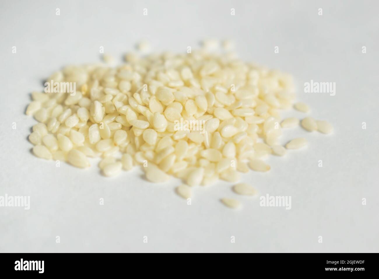 White Sesame seeds are flat, pear-shaped seeds with an off-white color Stock Photo