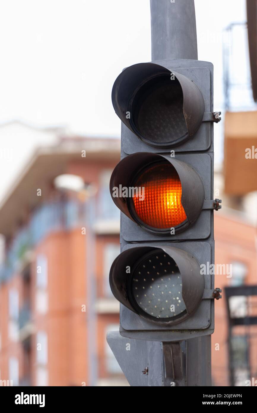 Traffic light with a flashing orange light, a caution sign Stock Photo