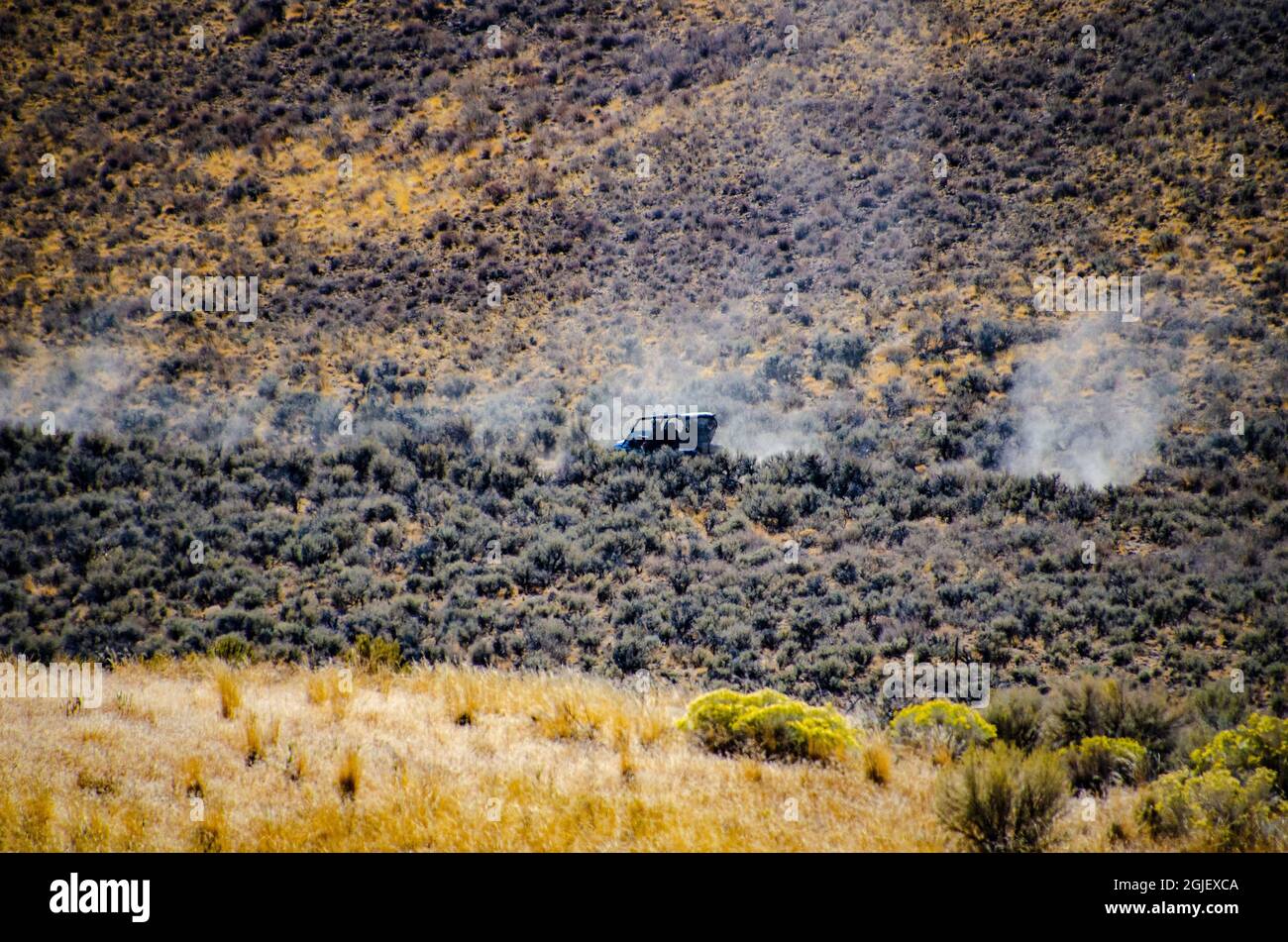 USA, California. Black Rock Desert, dusty trail of ATVs on High Rock