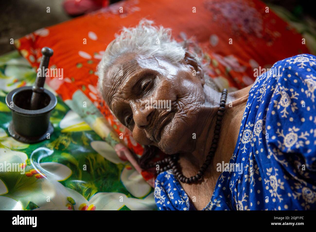 An elderly inhabitant having rest at her bed at Old Rehabilitation Center in Dhaka, Bangladesh. Stock Photo
