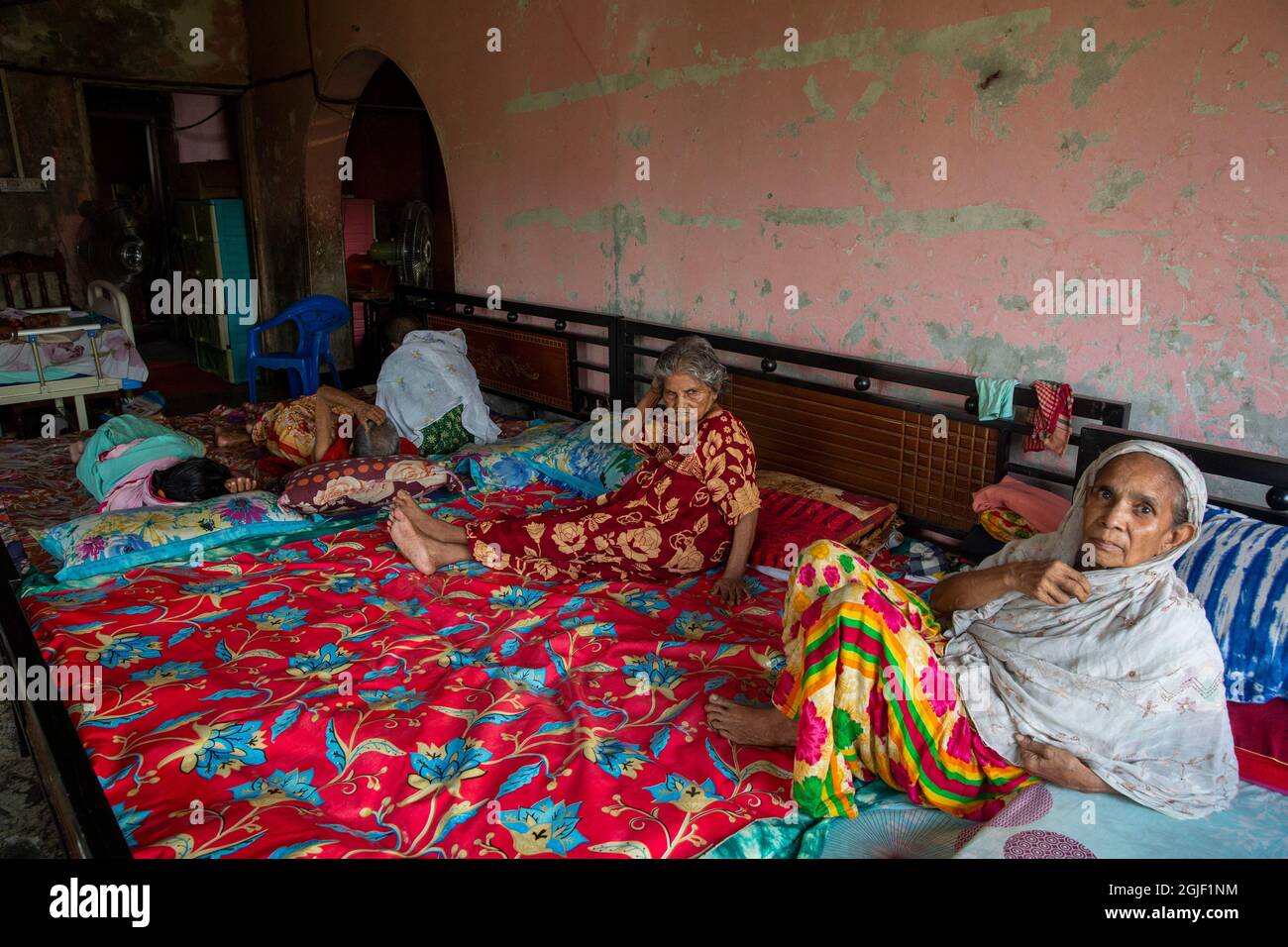 Elderly inhabitants having rest at their bed at Old Rehabilitation Center in Dhaka, Bangladesh. Stock Photo