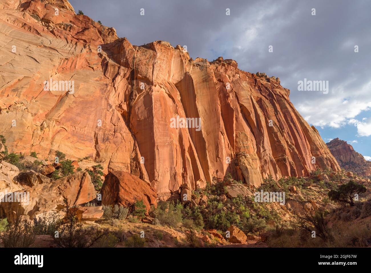 USA, Utah, Capitol Reef National Park, Storm clouds gather over steep cliffs of Wingate Sandstone near opening of Capitol Gorge. Stock Photo