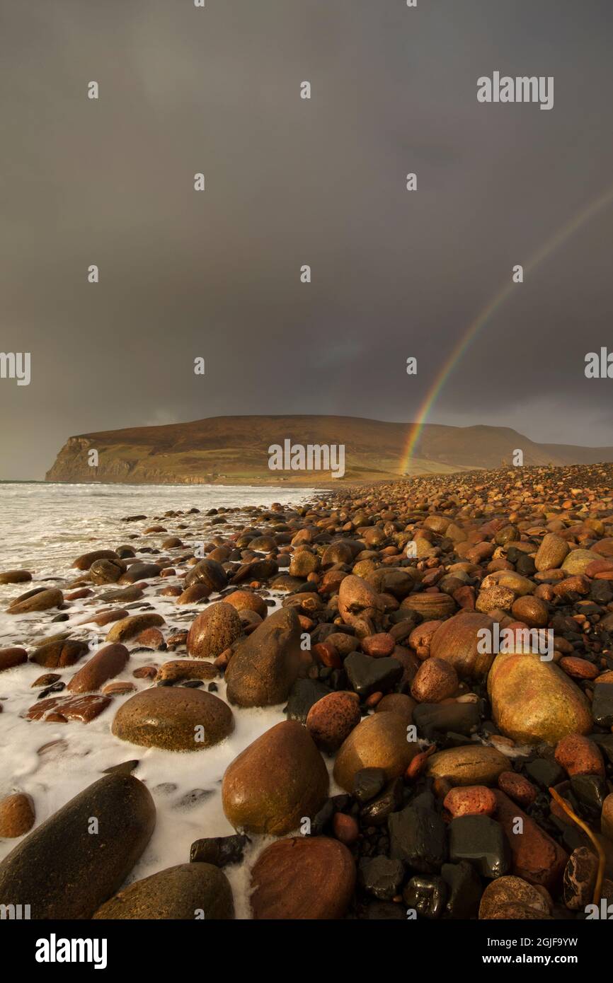 Rainbow at Rackwick Bay during winter storm, Orkney Isles Stock Photo