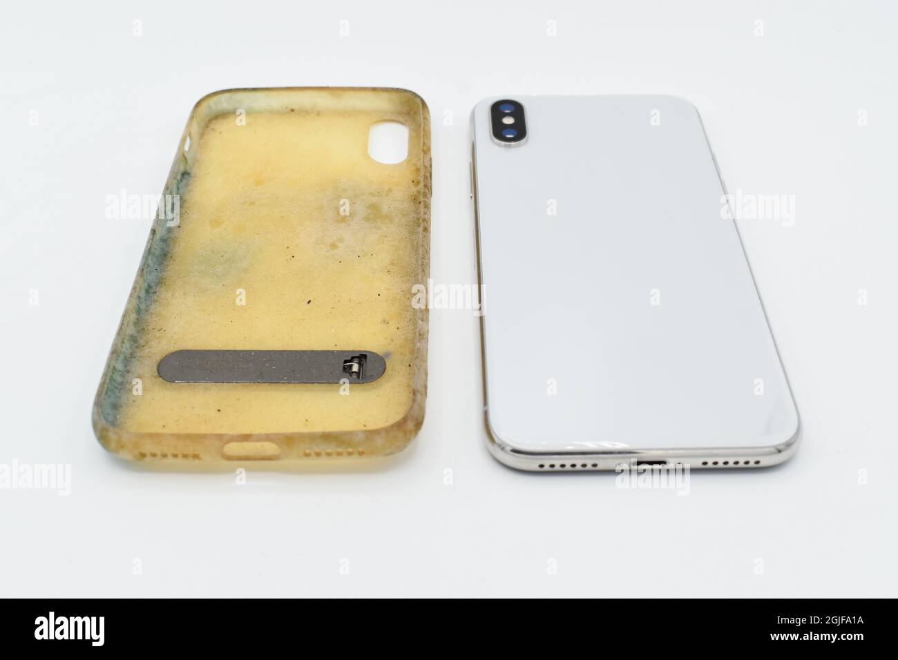 New smartphone and old and dirty silicon phone case due to yellow