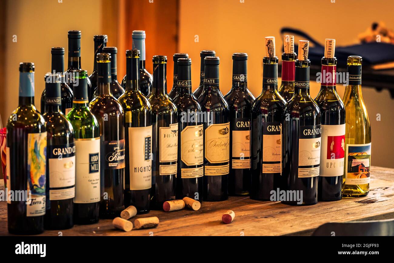 USA, Washington State, Red Mountain. A range of wine bottles opened for a tasting evaluation. Stock Photo