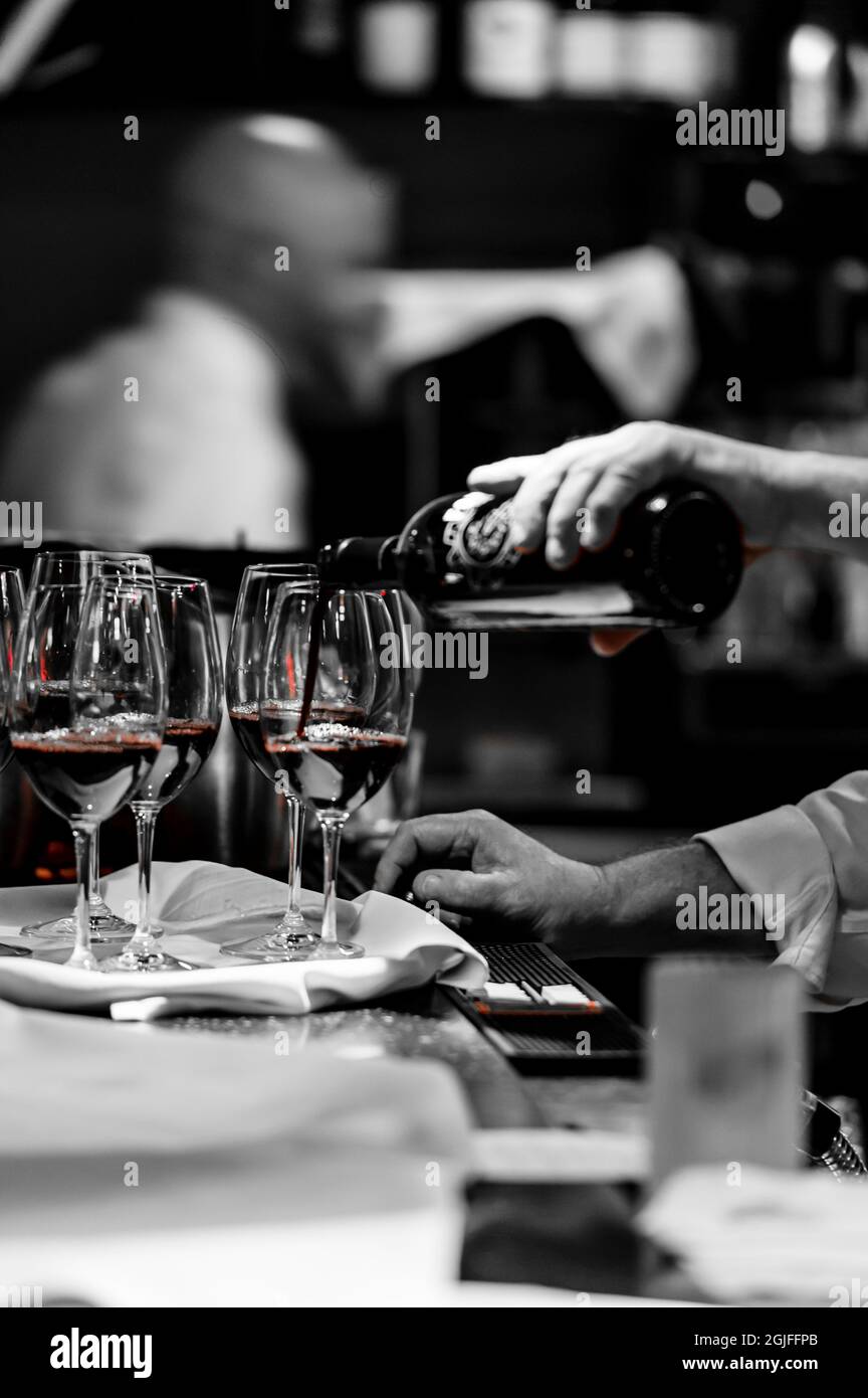USA, Washington State, University Place. Red wine pouring at a winemaker dinner. Stock Photo