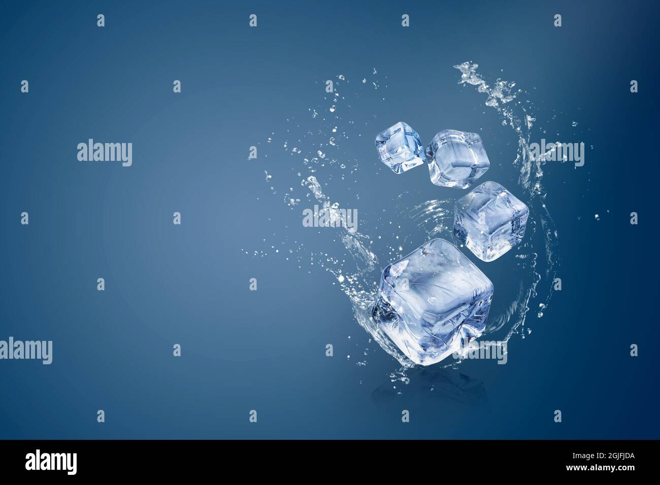 Water splashing on Ice cubes isolated over a blue background and copy space. Stock Photo