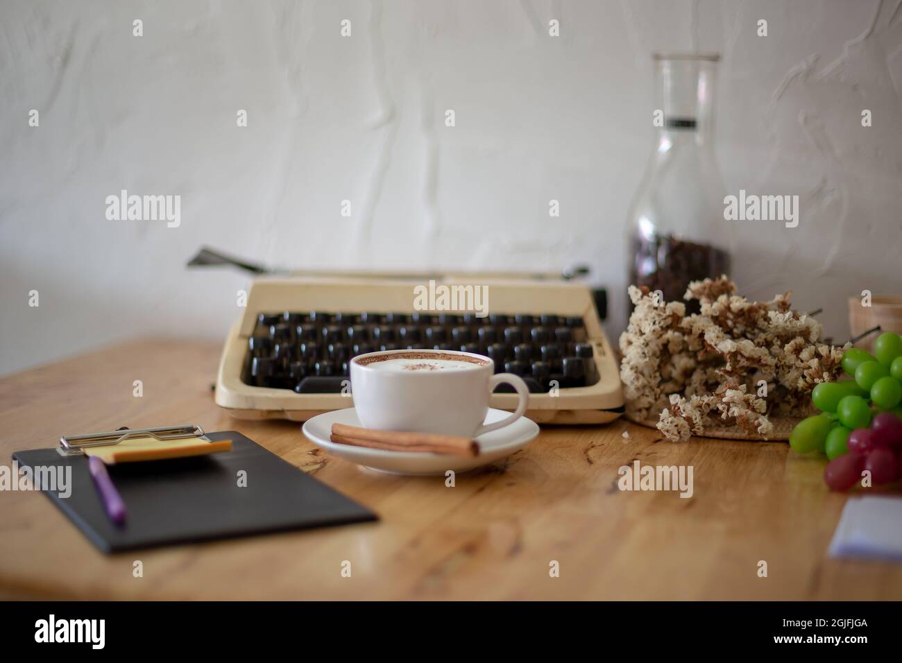 Vintage typewriters and Cup of Coffee on wooden table. Stock Photo