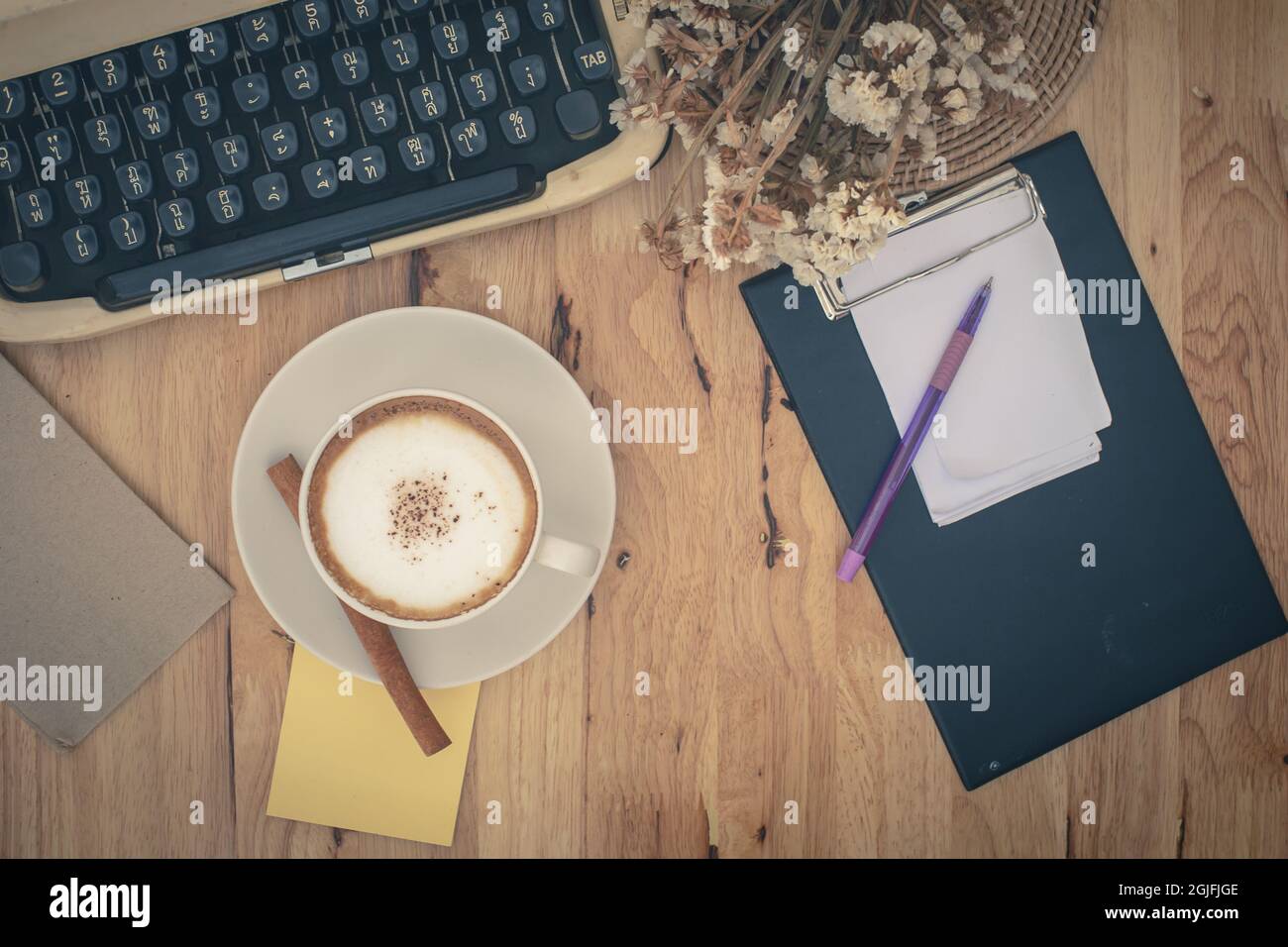 Vintage typewriters and Cup of Coffee on wooden table. Stock Photo