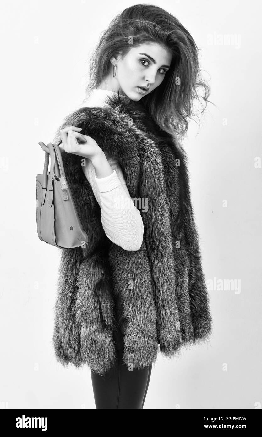 Woman in fur coat with handbag on white background. Girl fashion lady
