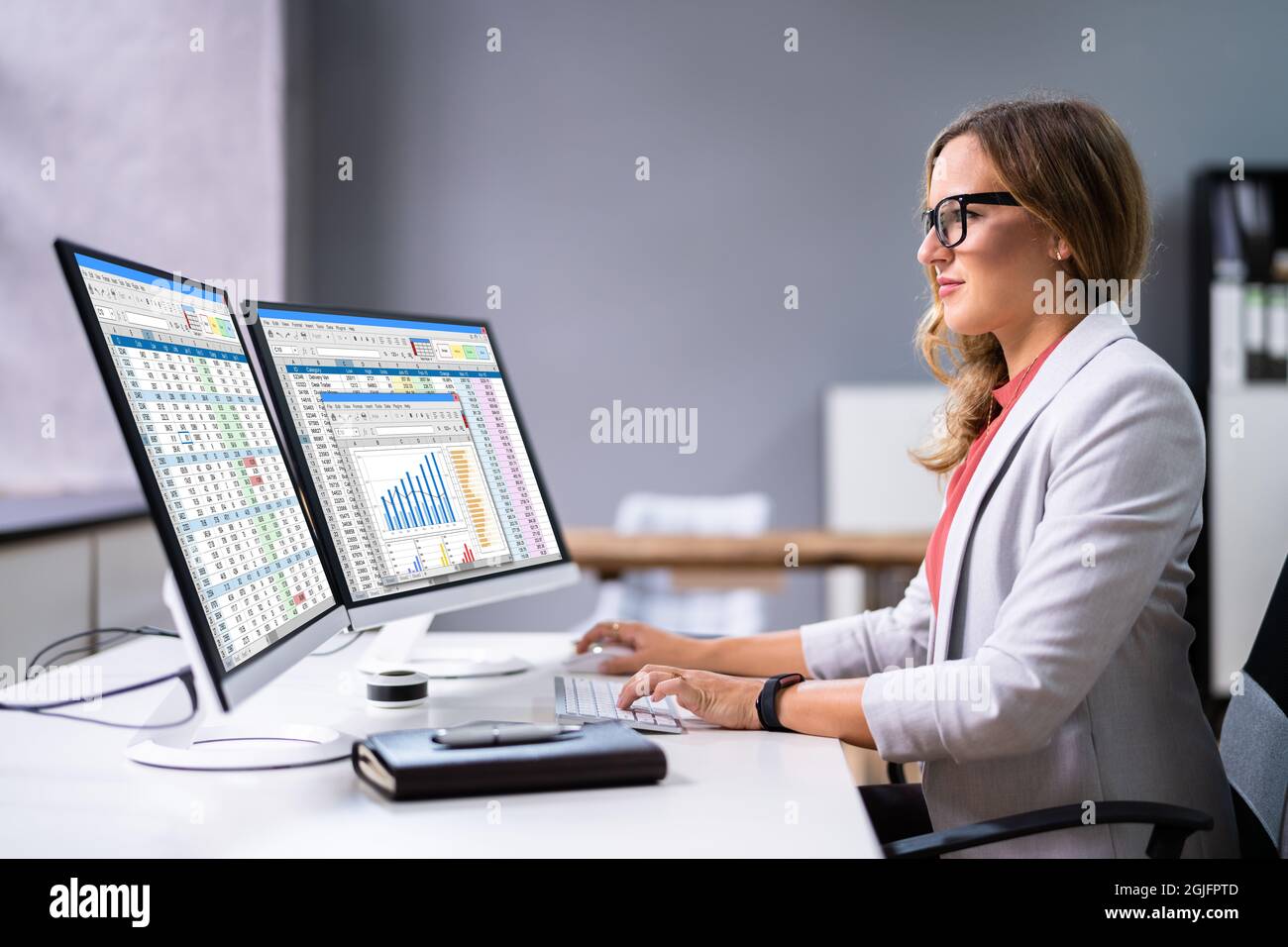 Financial Analyst Using Spreadsheet Software On Desktop Computer Stock