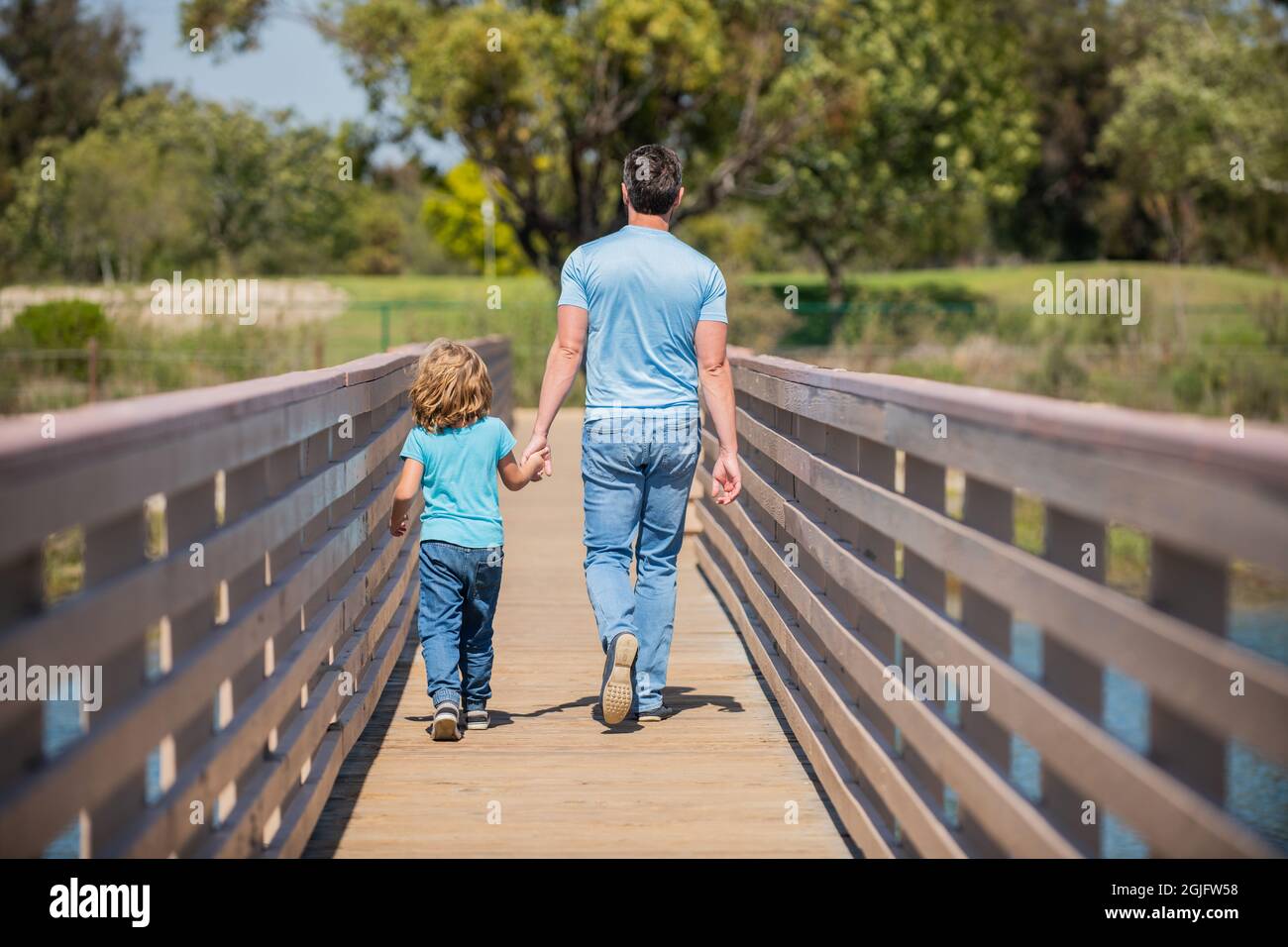 childhood and parenthood. parent relax with little child boy. dad with kid on summer Stock Photo