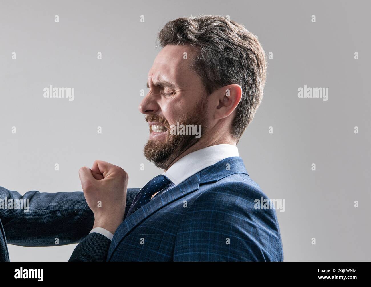 Defending against punch attack. Scared man being punched. Lawyer suffer from workplace aggression Stock Photo