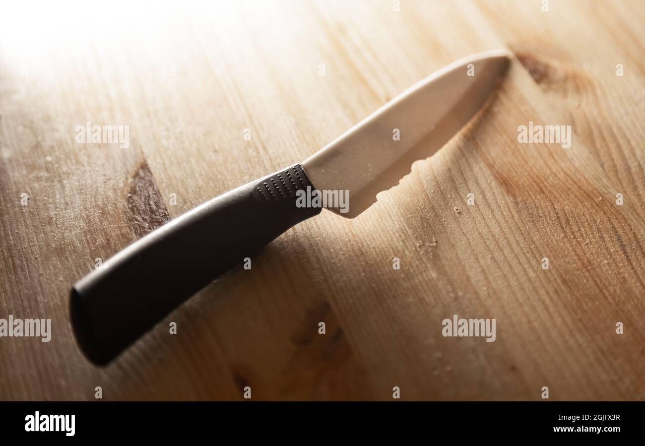 close up old white ceramic knife with a chipped blade. broken