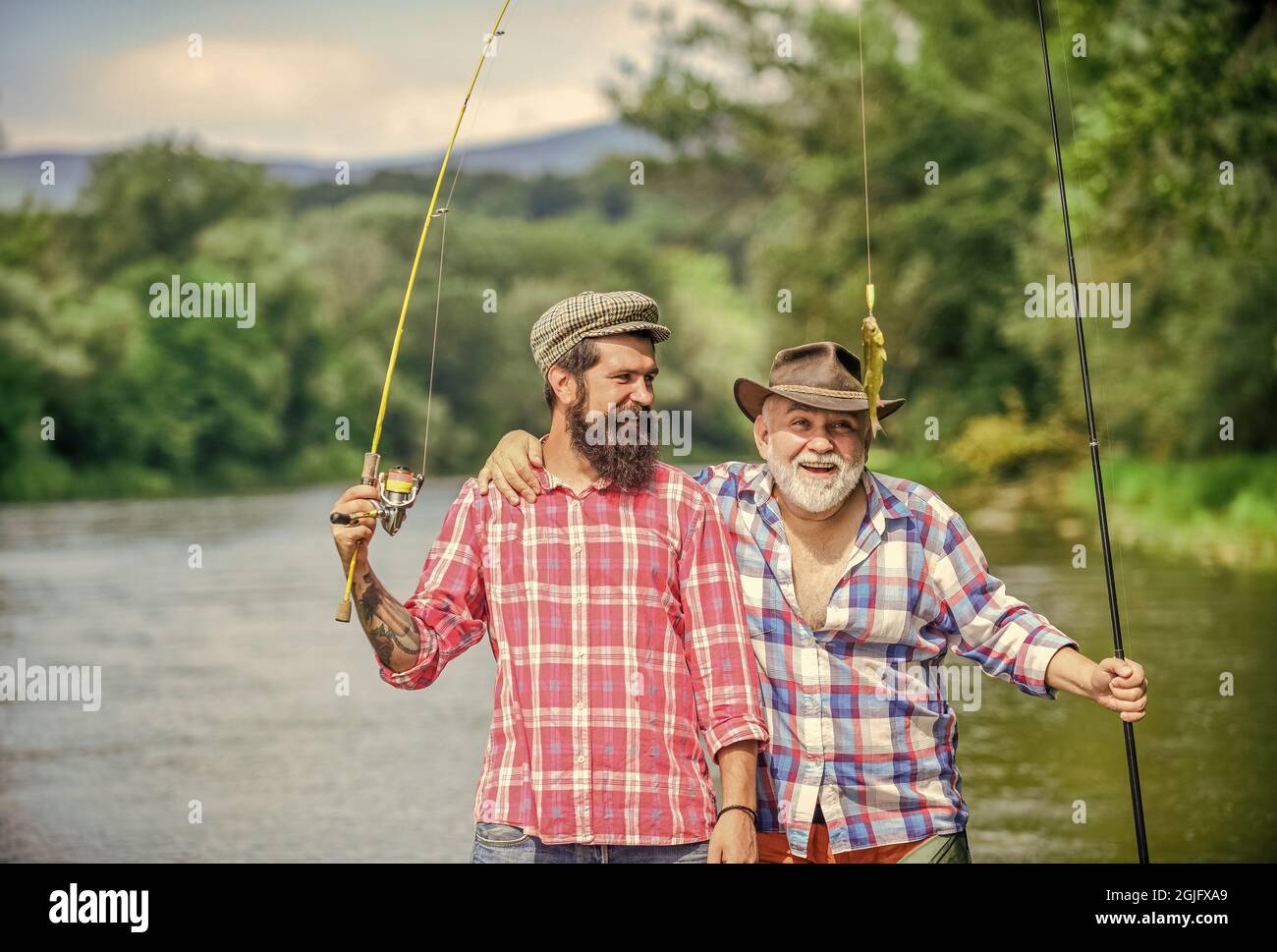 https://c8.alamy.com/comp/2GJFXA9/family-time-activity-and-hobby-fishing-freshwater-lake-pond-river-fisherman-with-fishing-rod-bearded-men-catching-fish-mature-man-with-friend-fis-2GJFXA9.jpg