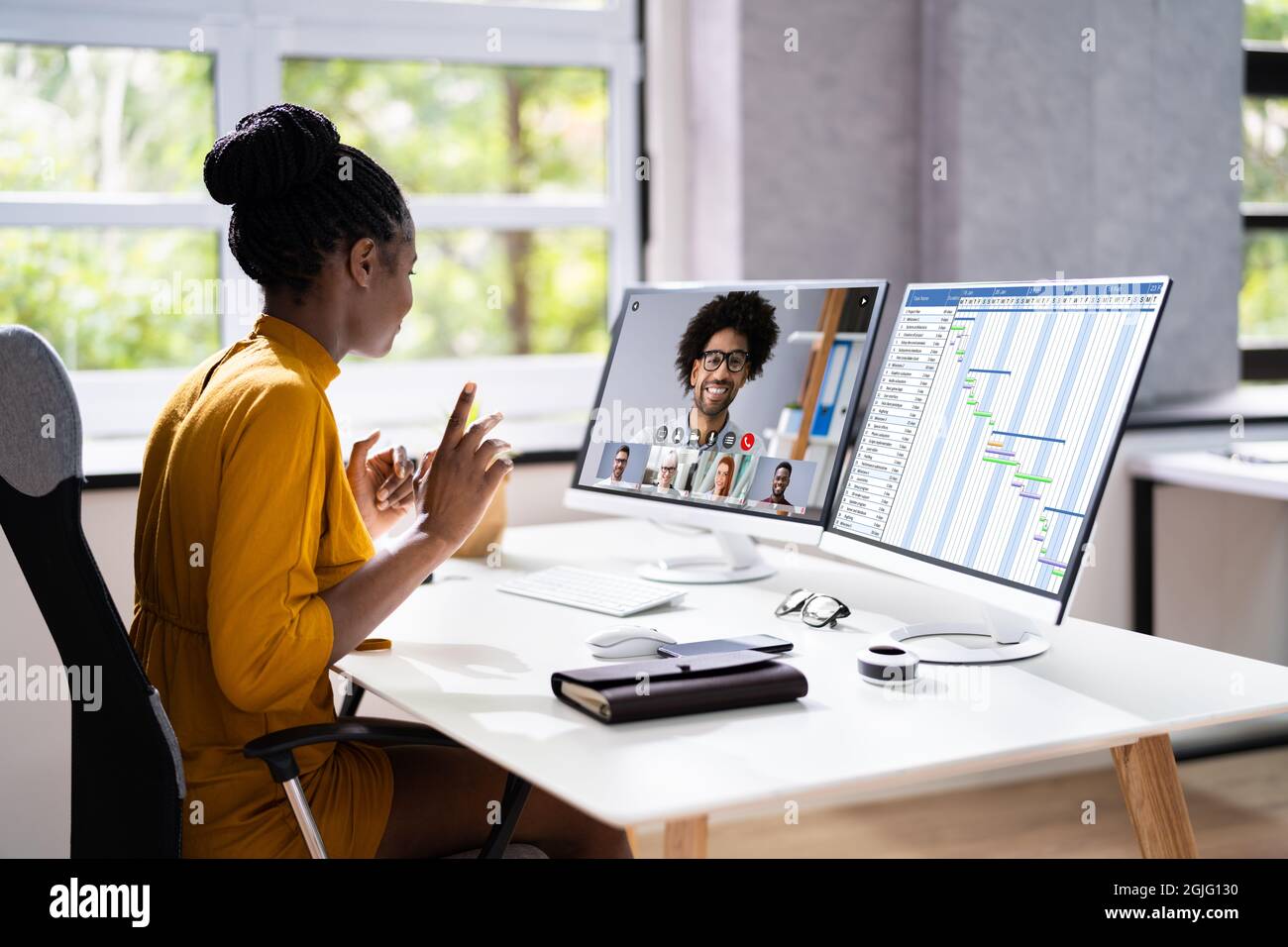 Virtual Conference Agenda On Multiple Computers In Office Stock Photo -  Alamy