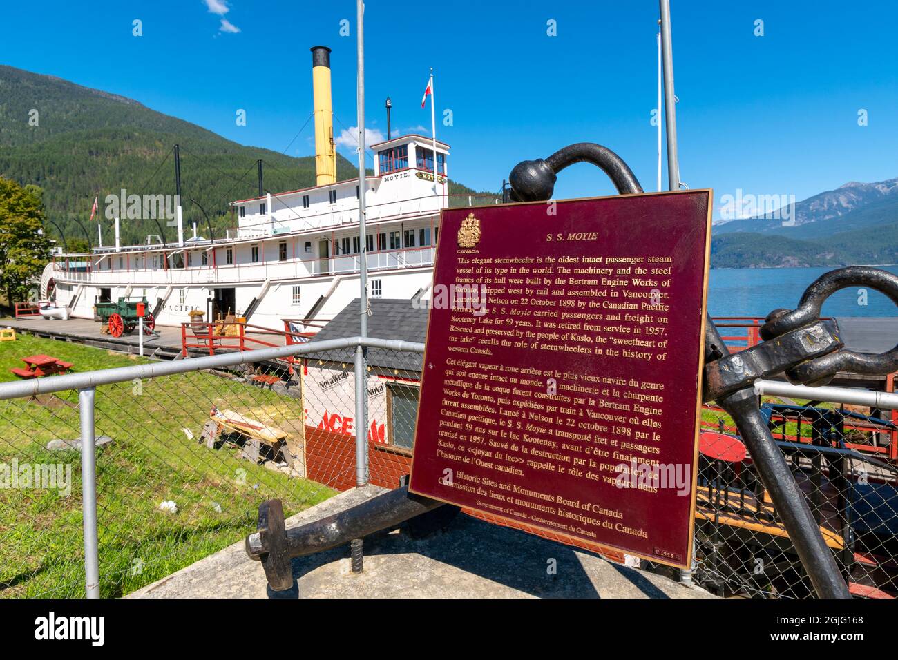 The Sternwheeler Paddlewheel boat SS Moyie, now a tourist attraction on the banks of Kootenay Lake at summer with the information sign Stock Photo