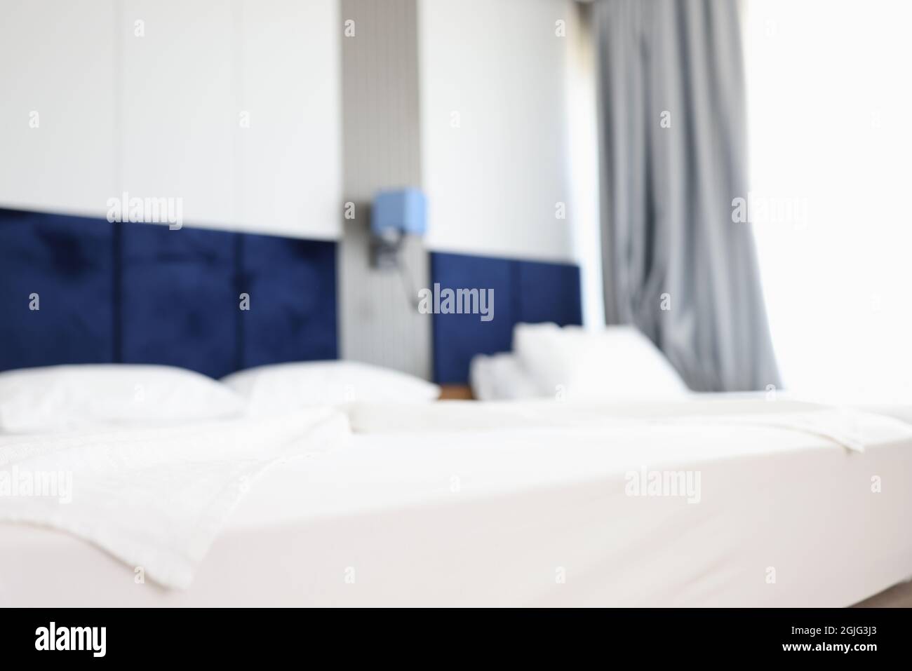 Modern hotel bedroom with two beds blurred background Stock Photo