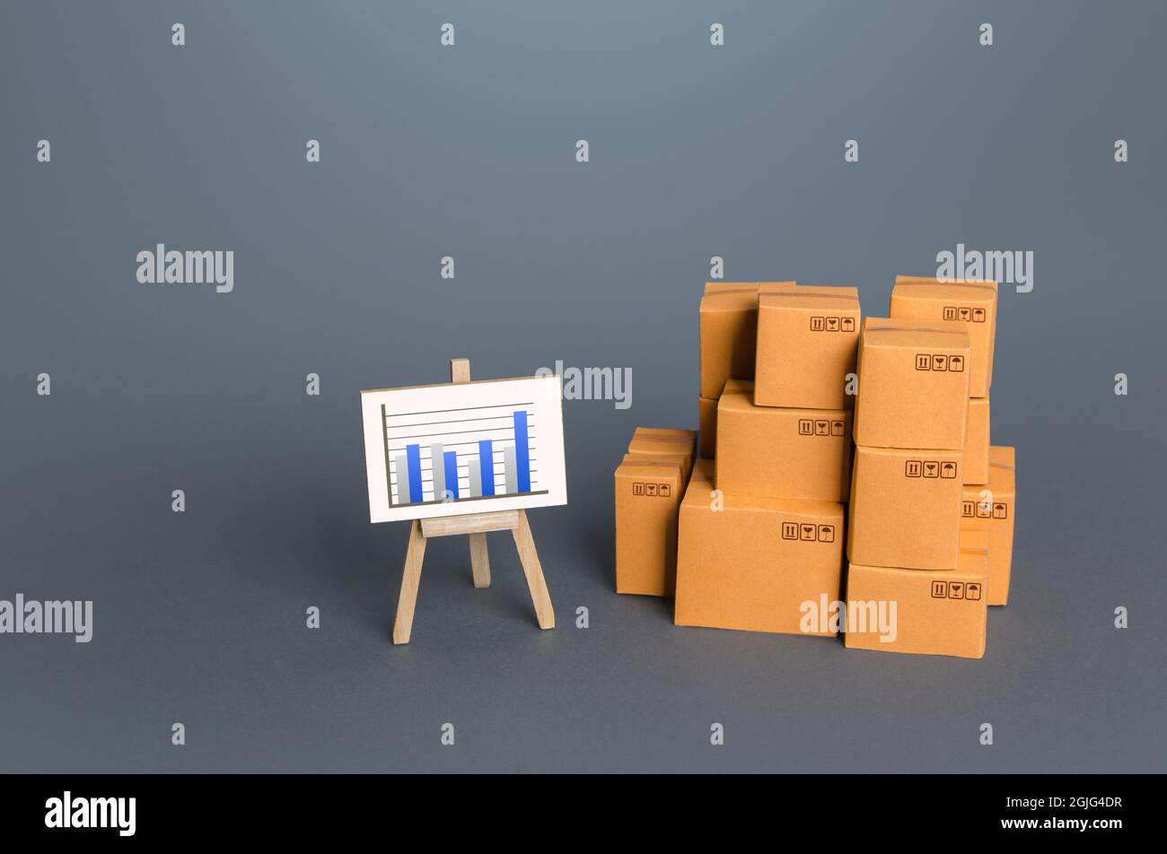 Boxes and easel with charts. Analytical data on cargo transportation and trade. Trade balance, imports and exports ratio. Profits and expenses. Consum Stock Photo