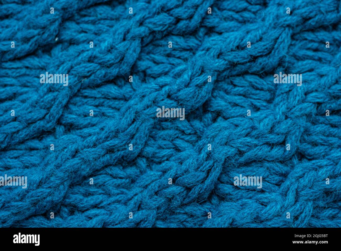 Blue background with large knitted thread pattern Stock Photo - Alamy
