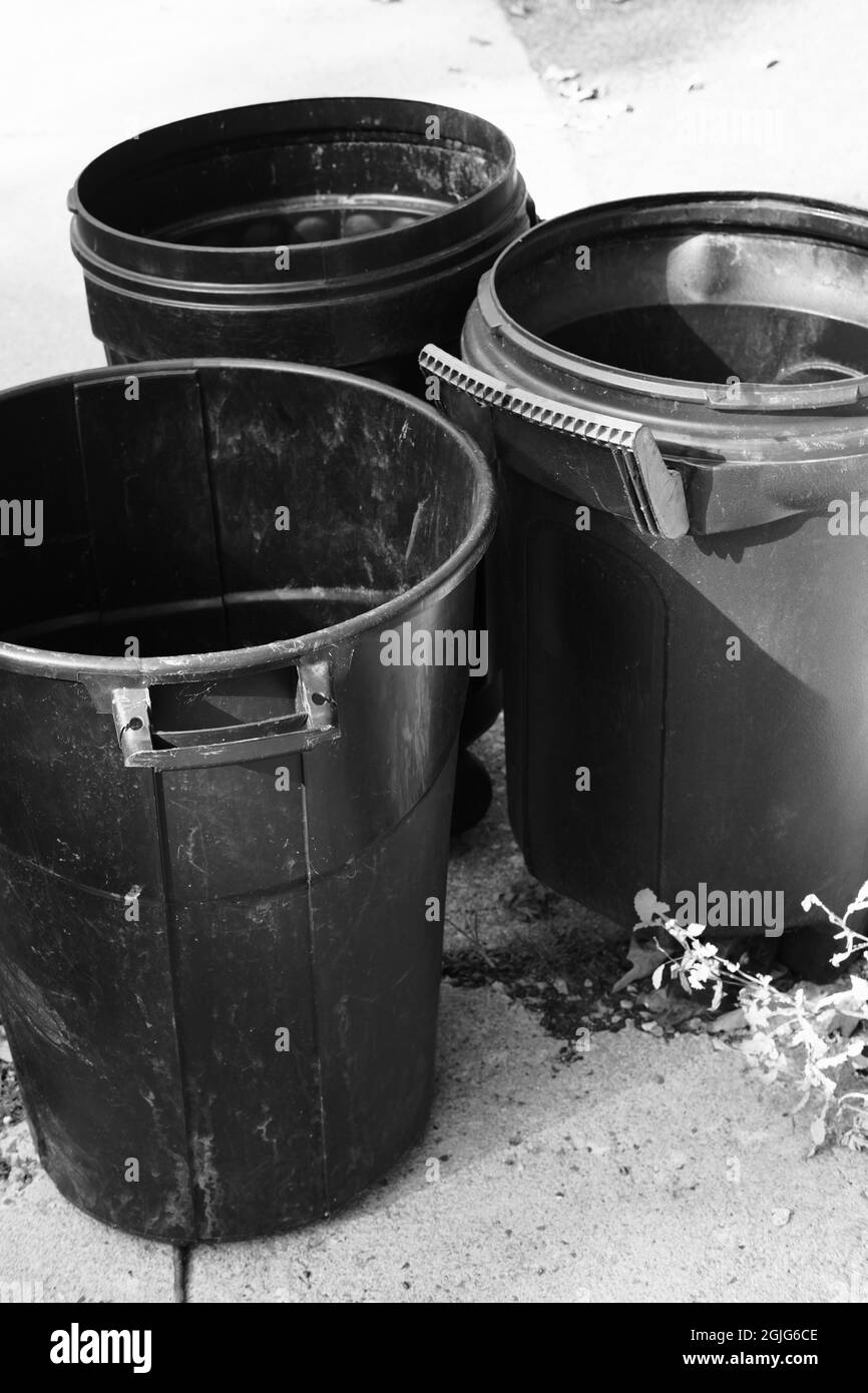 Several empty garbage cans at the end of the driveway Stock Photo Alamy