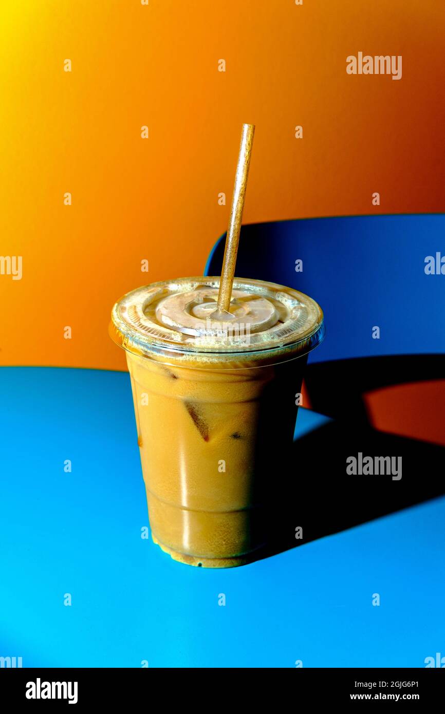 Retro stylized plastic cup of iced coffee with milk and sugar with  biodegradable straw Stock Photo - Alamy