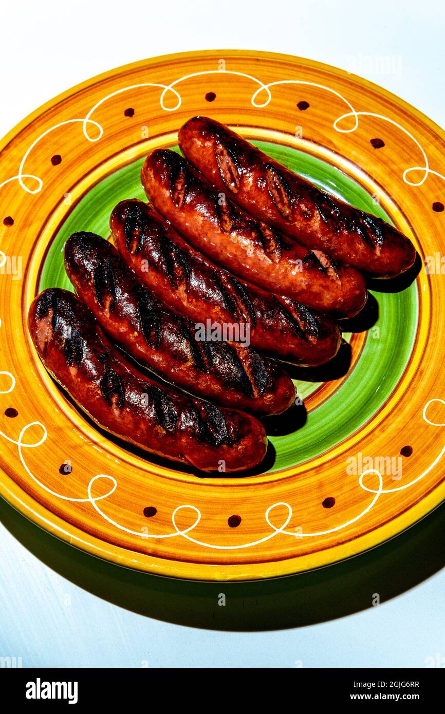 Five char-grilled kielbasa sausages on colorful plate Stock Photo - Alamy
