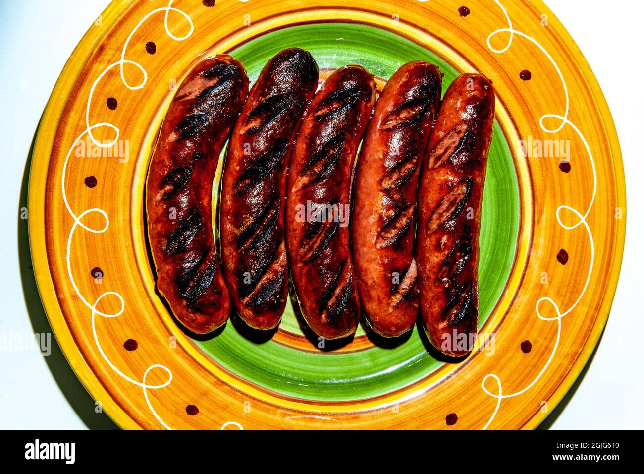 Five chargrilled kielbasa sausages on colorful plate Stock Photo Alamy
