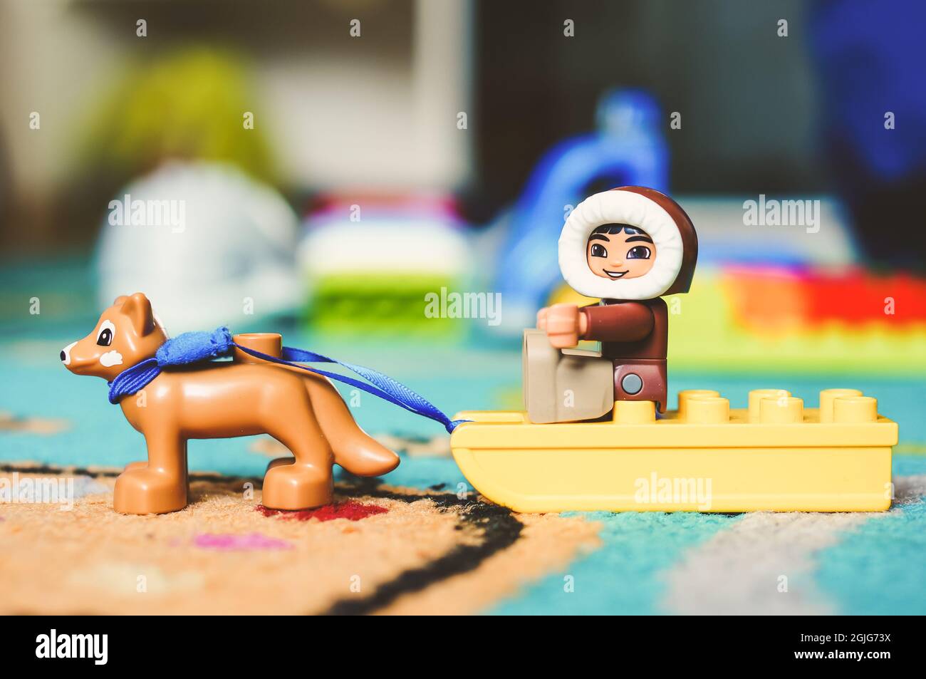 POZNAN, POLAND - Feb 19, 2017: Lego Duplo toy eskimo sitting on a sled with  dog on a carpet in soft focus Stock Photo - Alamy