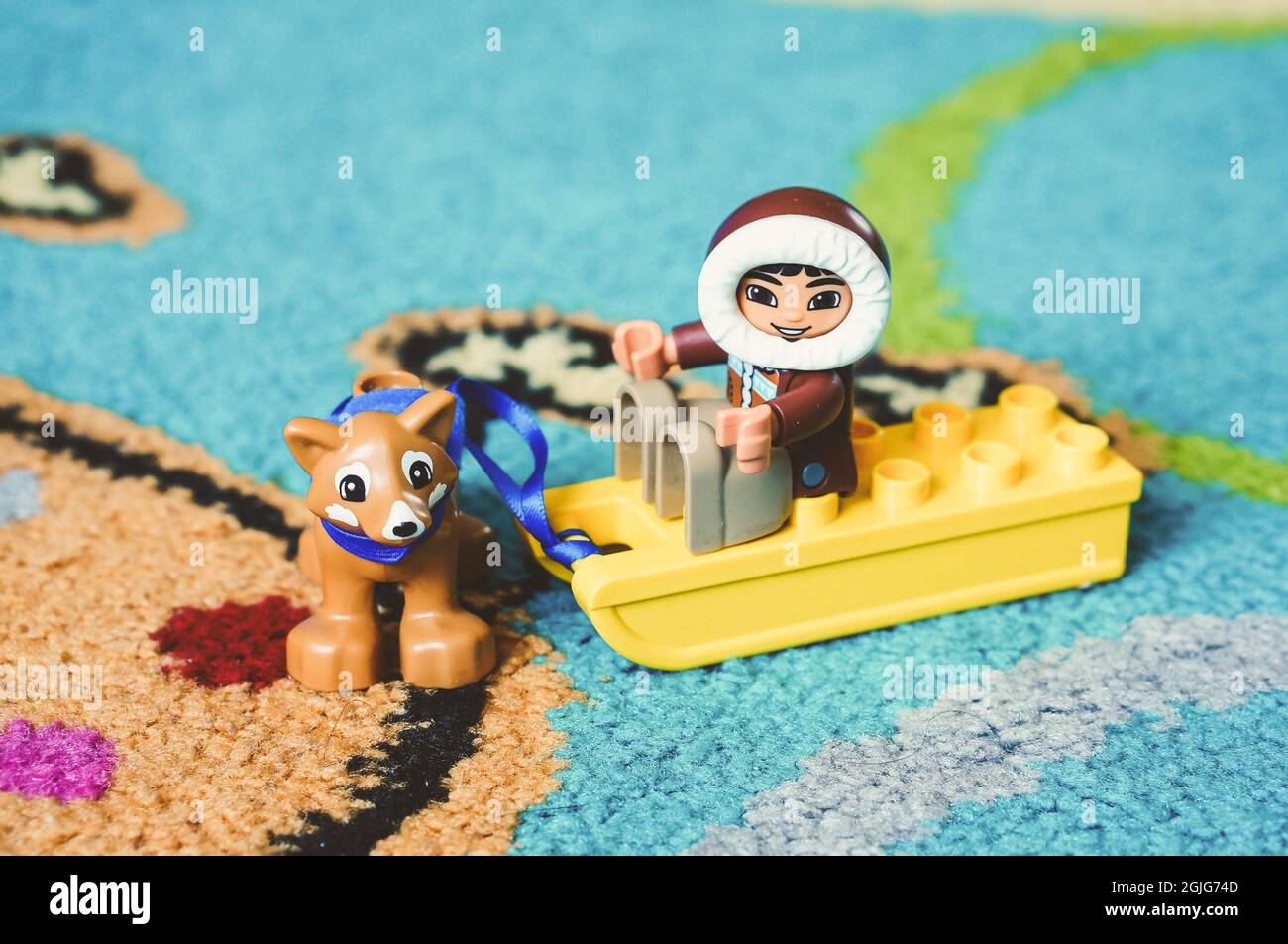 POZNAN, POLAND - Feb 19, 2017: Lego Duplo toy eskimo sitting on a sled with  dog on a carpet in soft focus Stock Photo - Alamy