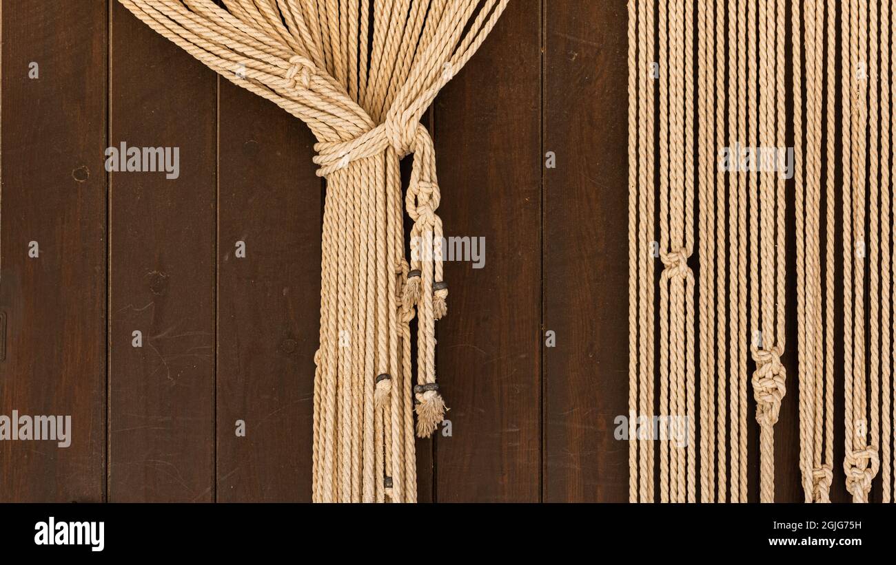 Curtain backdrop of gathered rope on rustic wooden door Stock Photo - Alamy