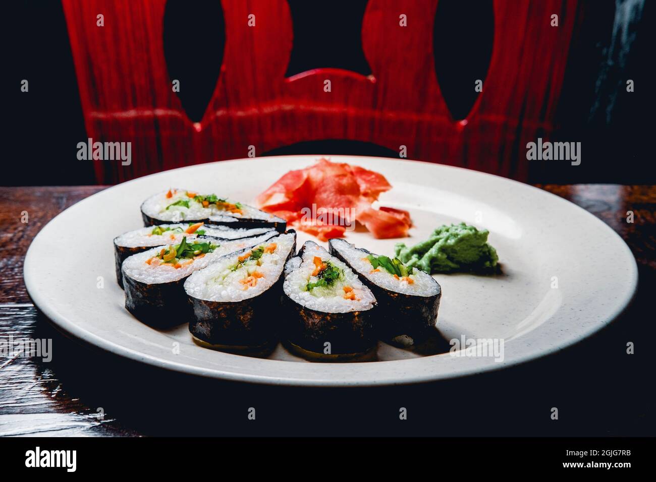 Vegetable sushi arranged in pinwheel shape with pickled ginger and