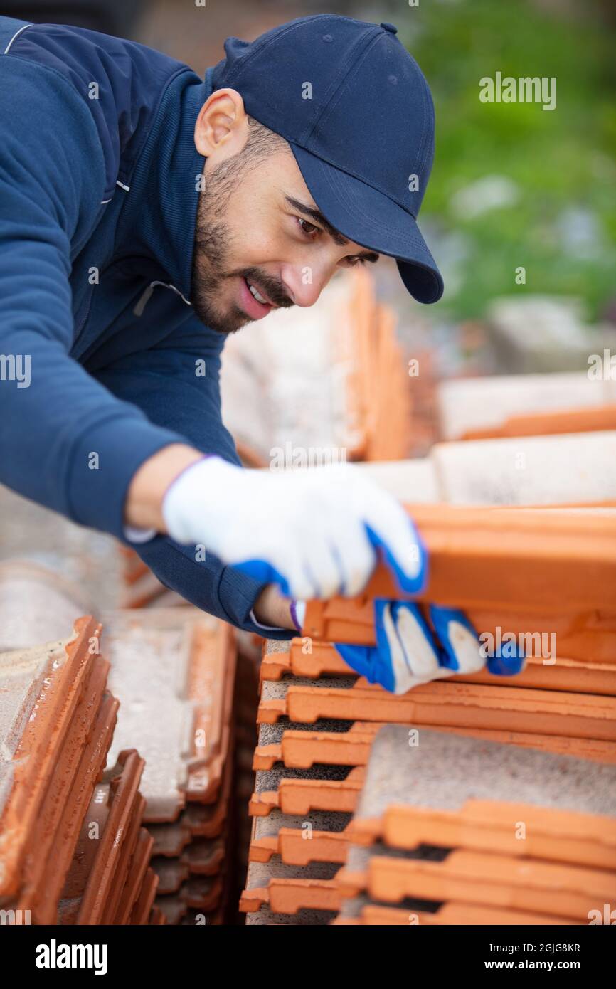 bricklayer working with ceramsite concrete blocks walling Stock Photo