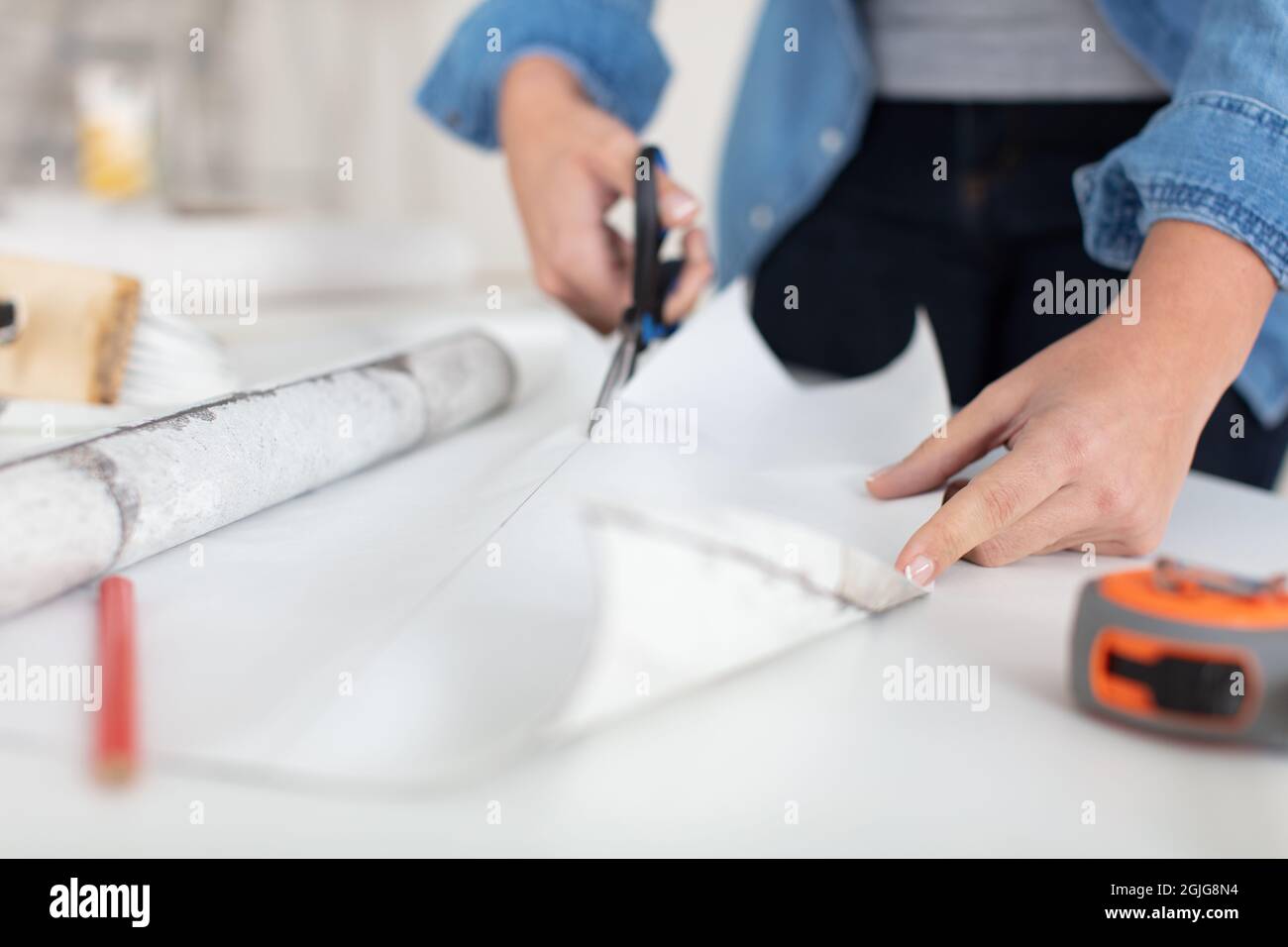close up woman using scissors at home Stock Photo