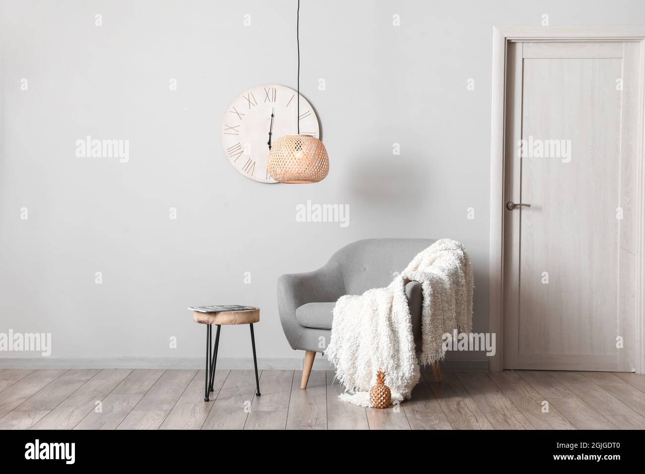 Interior of stylish modern room with armchair and table Stock Photo - Alamy