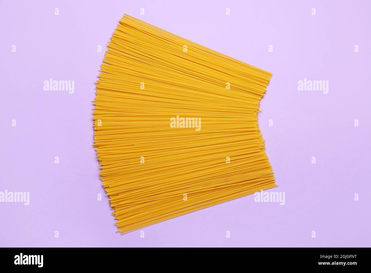 Uncooked spaghetti pasta on color background Stock Photo - Alamy