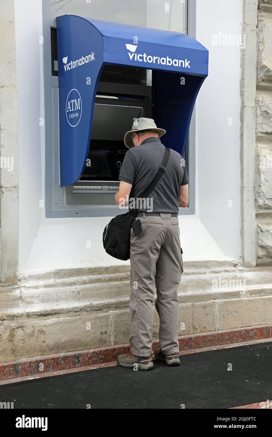 Tourist at Victoriabank ATM in Chisinau Stock Photo