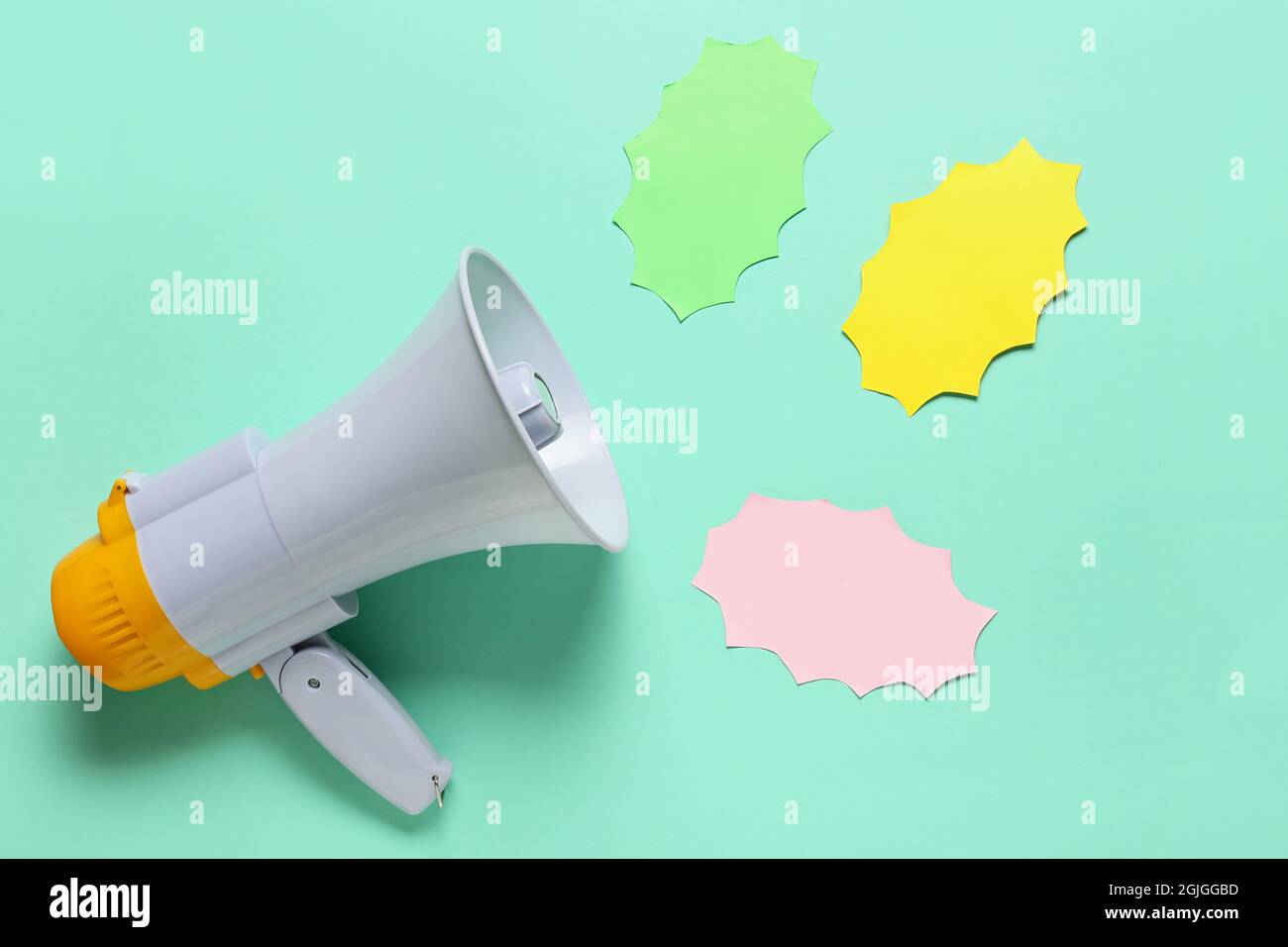 Modern megaphone and speech bubbles on color background Stock Photo - Alamy