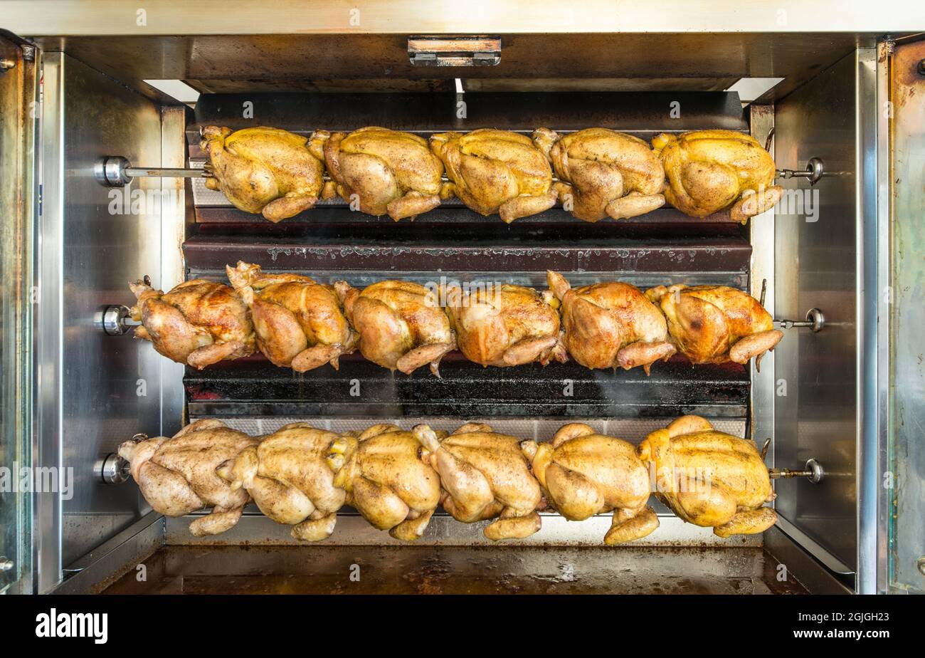 Oven full of roast chickens cooking in their juices Stock Photo Alamy