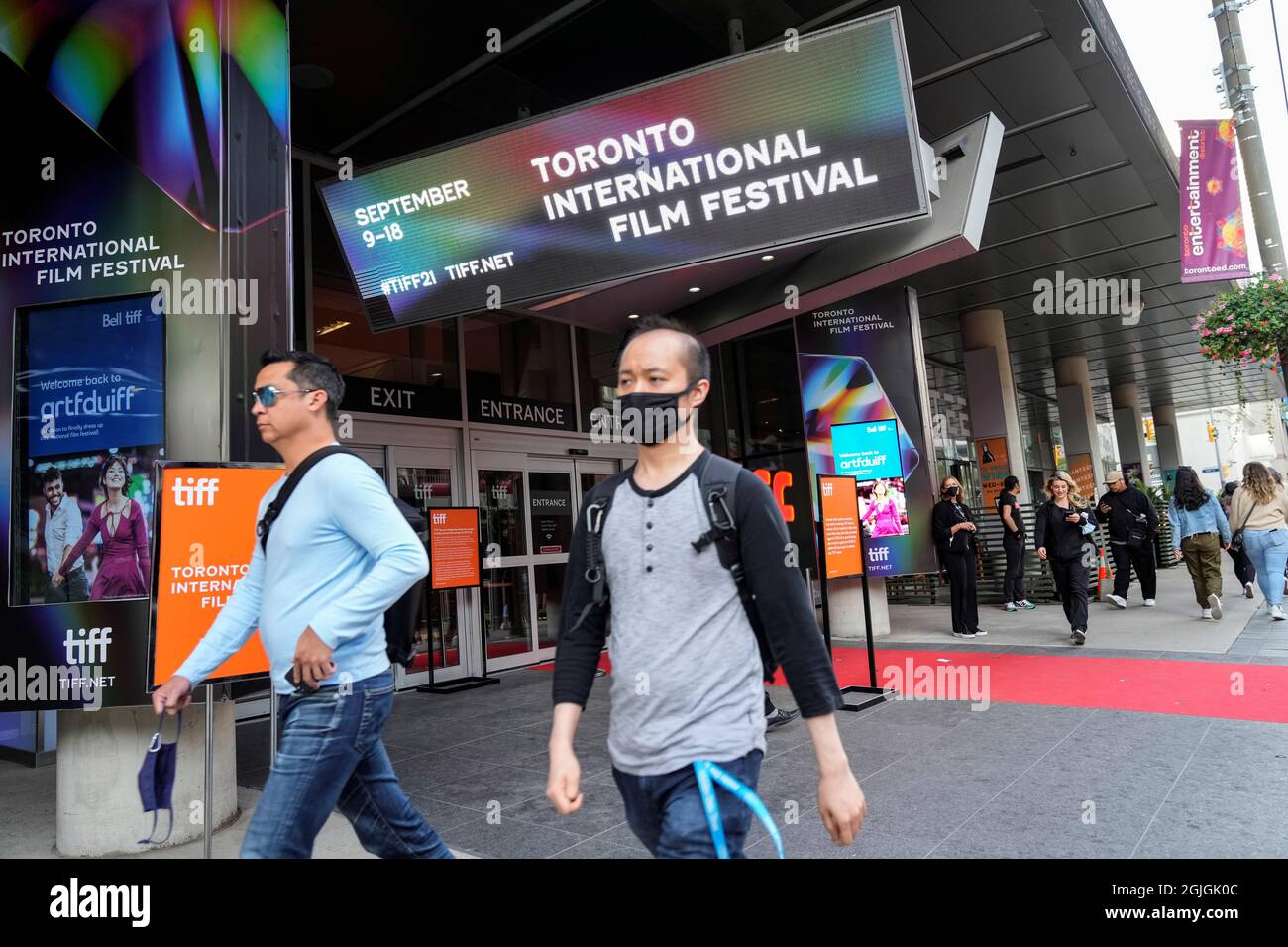 People walk outside the TIFF Bell Lightbox building, headquarters of the Toronto International Film Festival (TIFF), in Toronto, Canada, September 9, 2021. REUTERS/Mark Blinch Stock Photo
