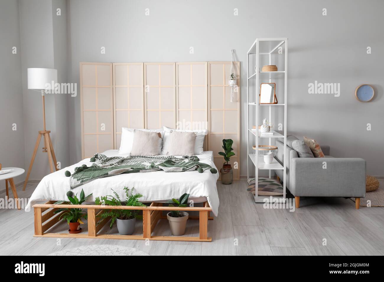 Interior of stylish bedroom with folding screen Stock Photo Alamy