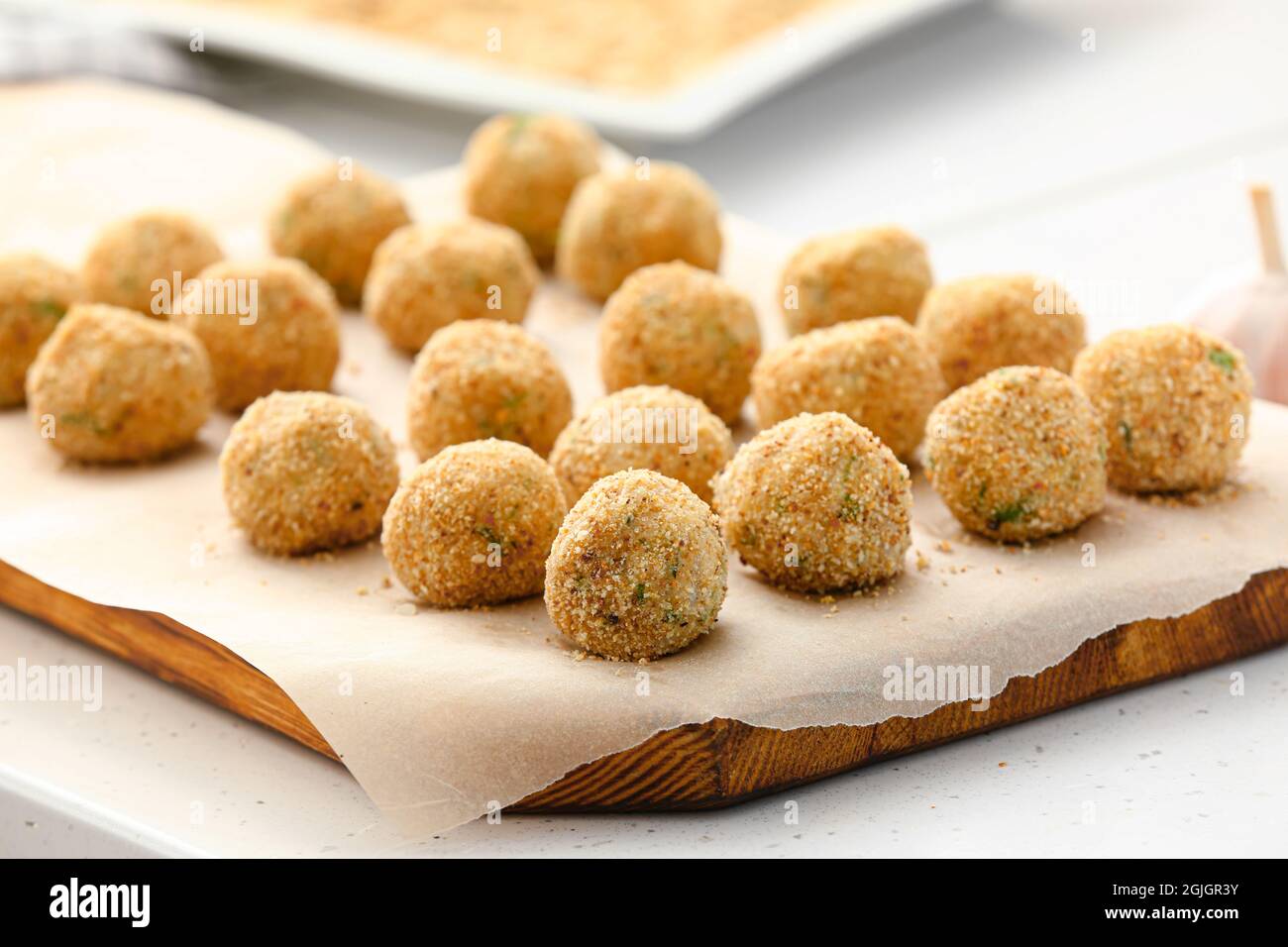 Board with uncooked cod cutlets on table, closeup Stock Photo - Alamy