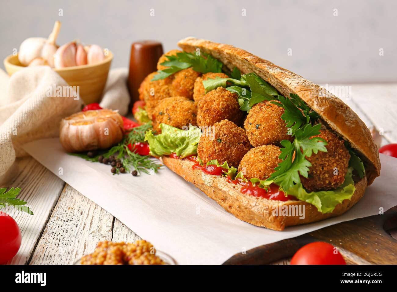 Board with bread and tasty cod cutlets on table, closeup Stock Photo